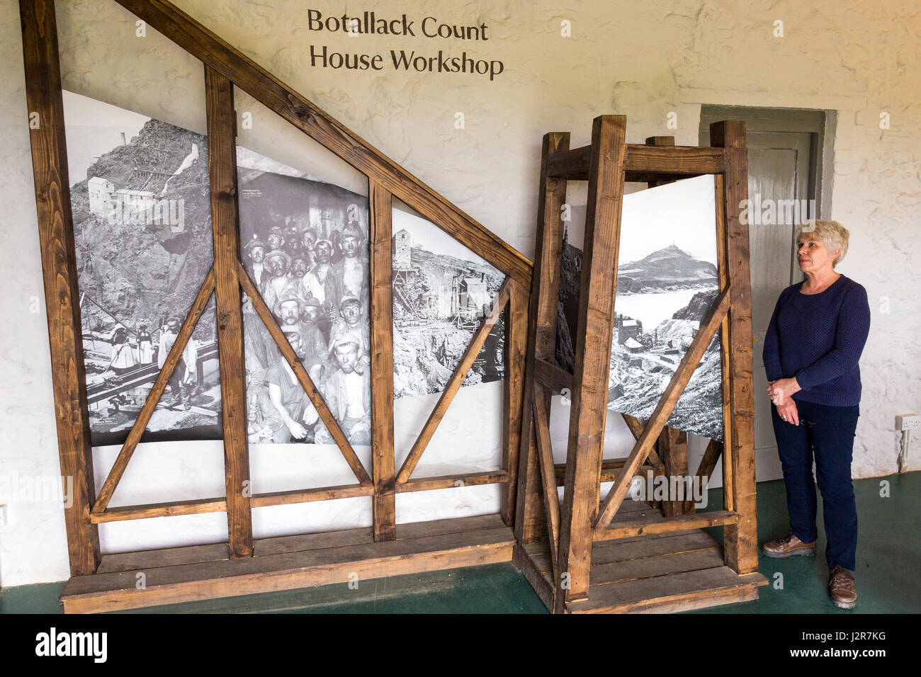 A visitor looking at the exhibition in the Botallack Count House Workshop at Botallack, Cornwall, England Stock Photo