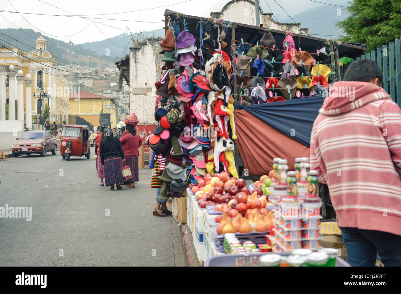 Totonicapan, Guatemala - February 10, 2015: Maya people and cars are seen in the streets of a small colonial town of Totonicapan in Guatemala on a bus Stock Photo