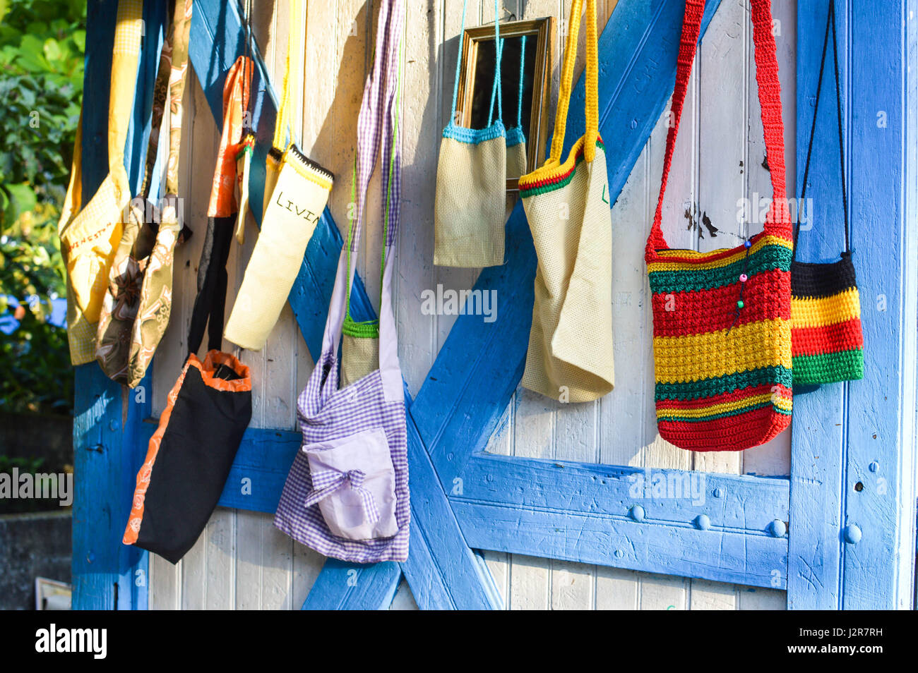 Handmade souvenir bags in Livingston, Guatemala. Central America. The word “Livin” visible on one of the bags is for “Livingston” – the name of the to Stock Photo