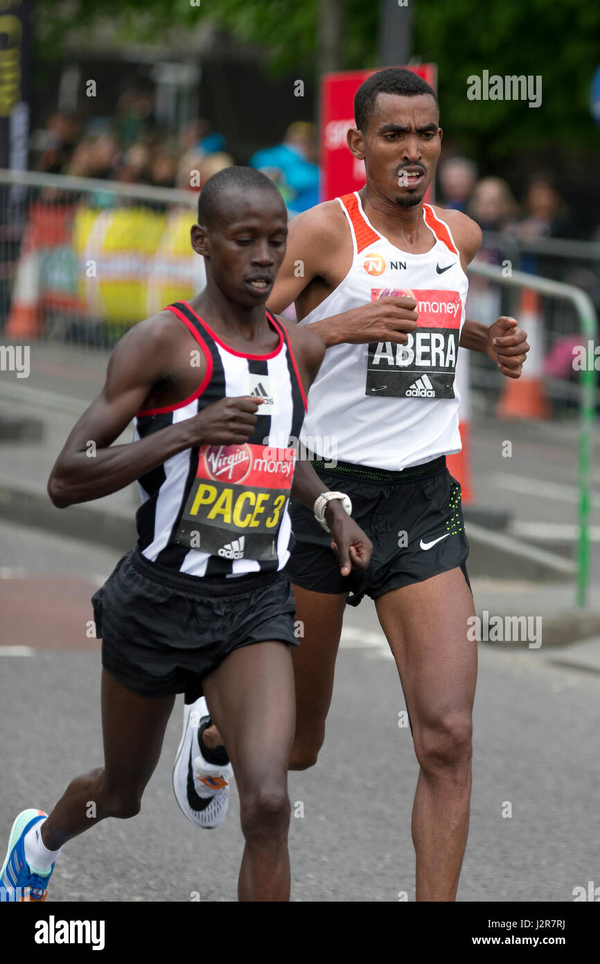 Tesfaye Abera & Pacemaker running in the Virgin Money London Marathon 2017,  The Highway, London, UK Stock Photo - Alamy