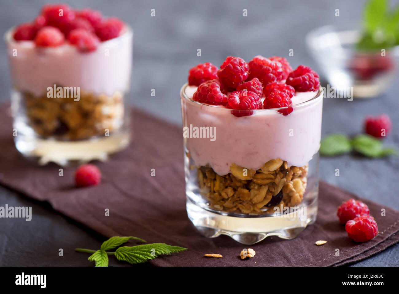 Homemade organic fresh parfait dessert with yogurt, raspberries and granola, selective focus Stock Photo