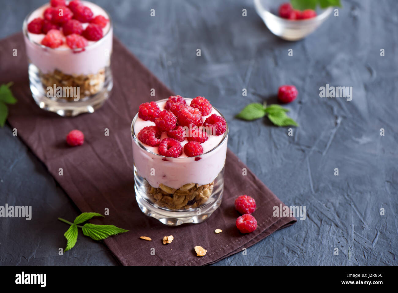 Homemade organic fresh parfait dessert with yogurt, raspberries and granola, selective focus Stock Photo