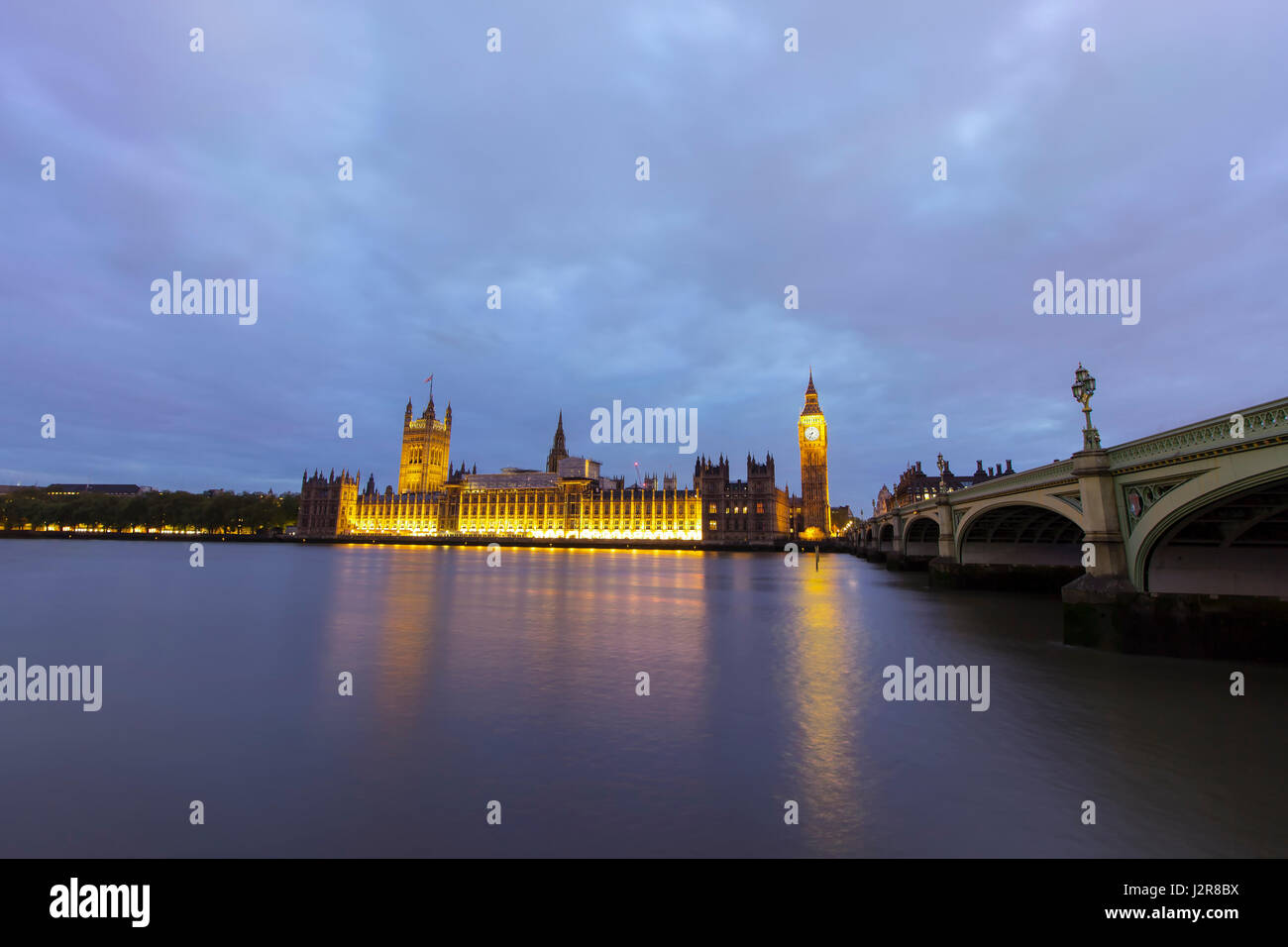 View of the tower of Big Ben and parliament buildings across the Thames river in Westminster, London. Photo taken on the 21st of March while buildings Stock Photo
