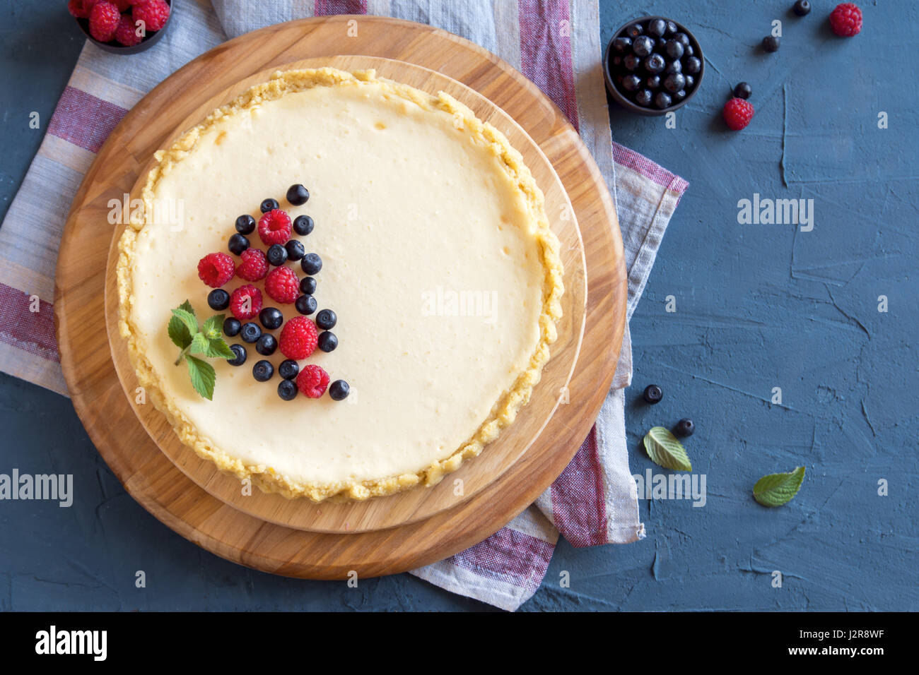 Homemade cheesecake with fresh berries and mint for dessert - healthy organic summer dessert pie cheesecake. Cheese cake. Stock Photo