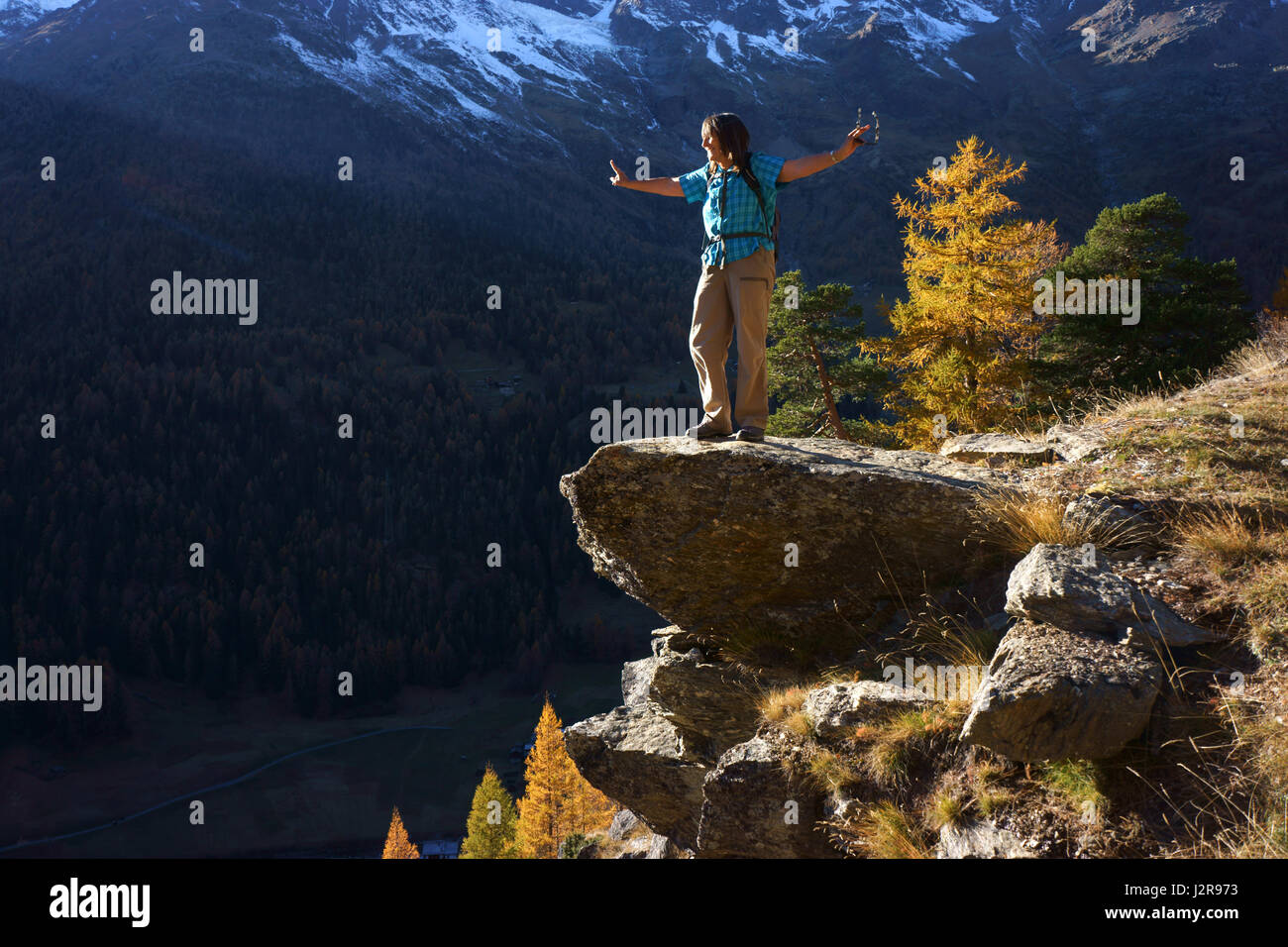 Hiker enjoying view above Saas valley, Valais alps, Switzerland Stock Photo
