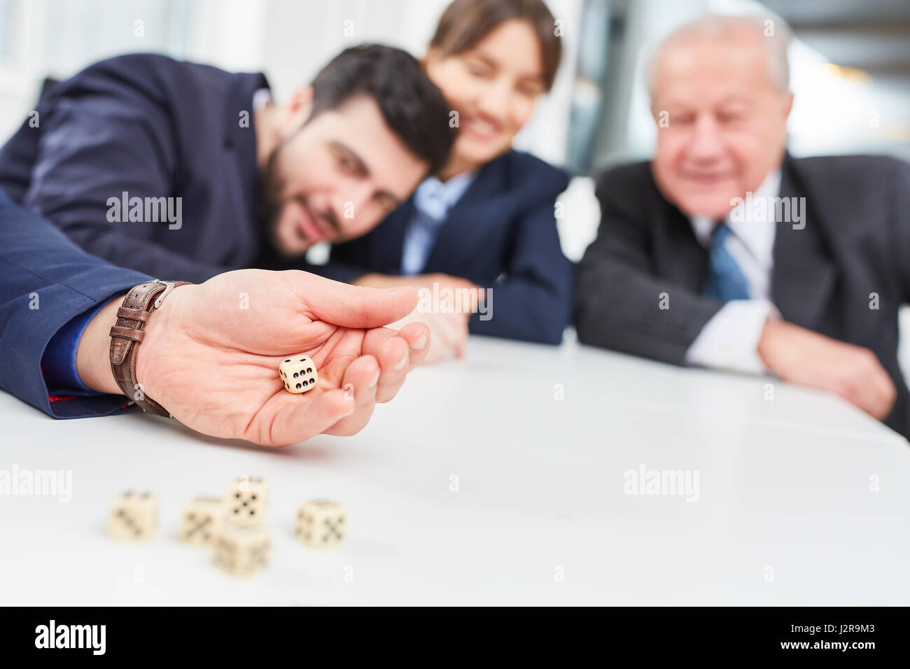 Team having fun playing dice game in business team building seminar Stock Photo