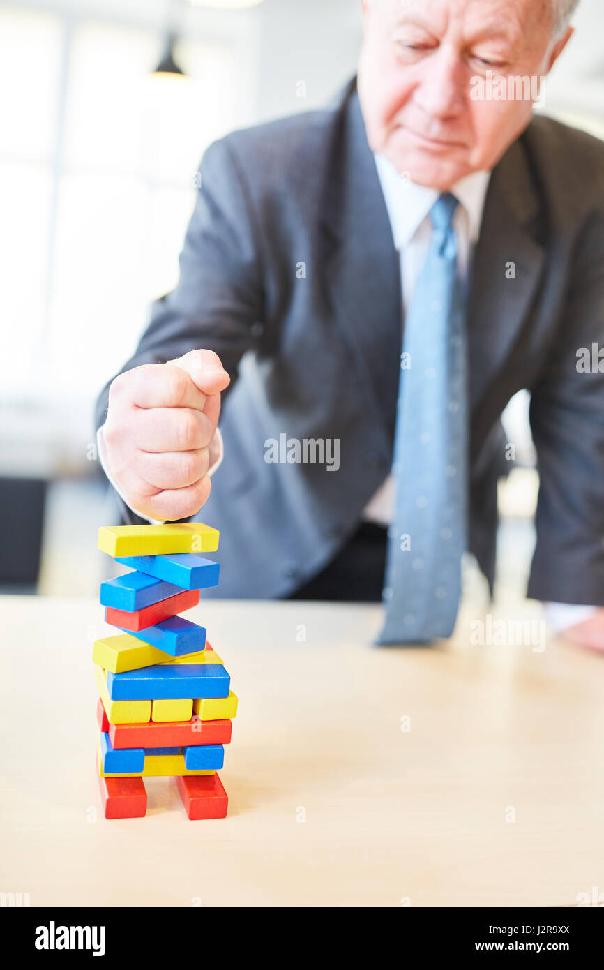 Manager shows determination and strength with clenched fist on color blocks Stock Photo