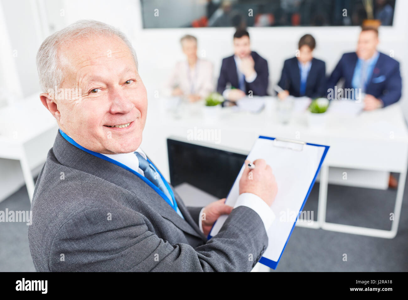 Senior citizen as experienced chief executive or boss gives lecture Stock Photo