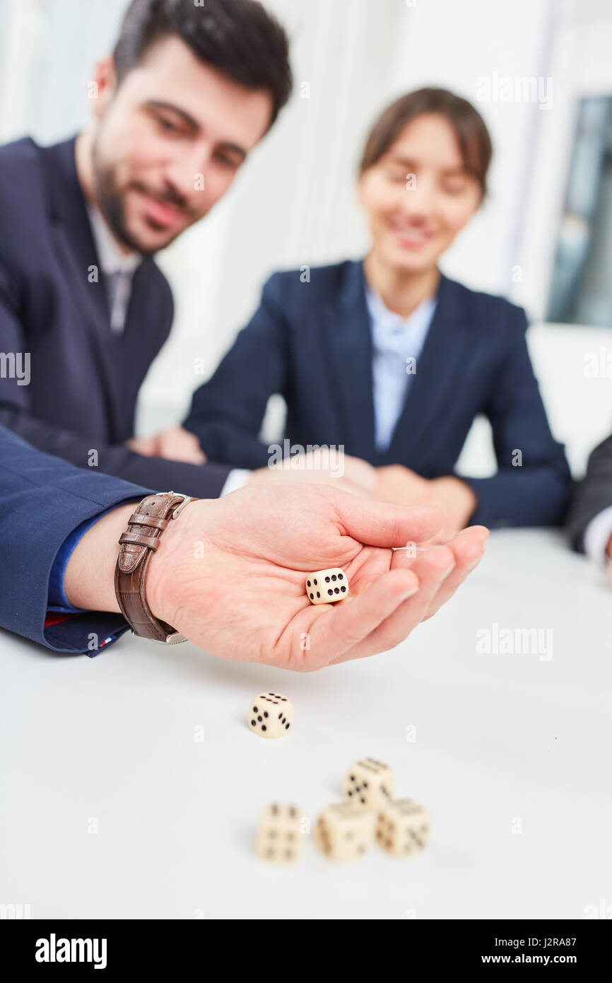 Business team in teambuilding workshop playing dice game Stock Photo