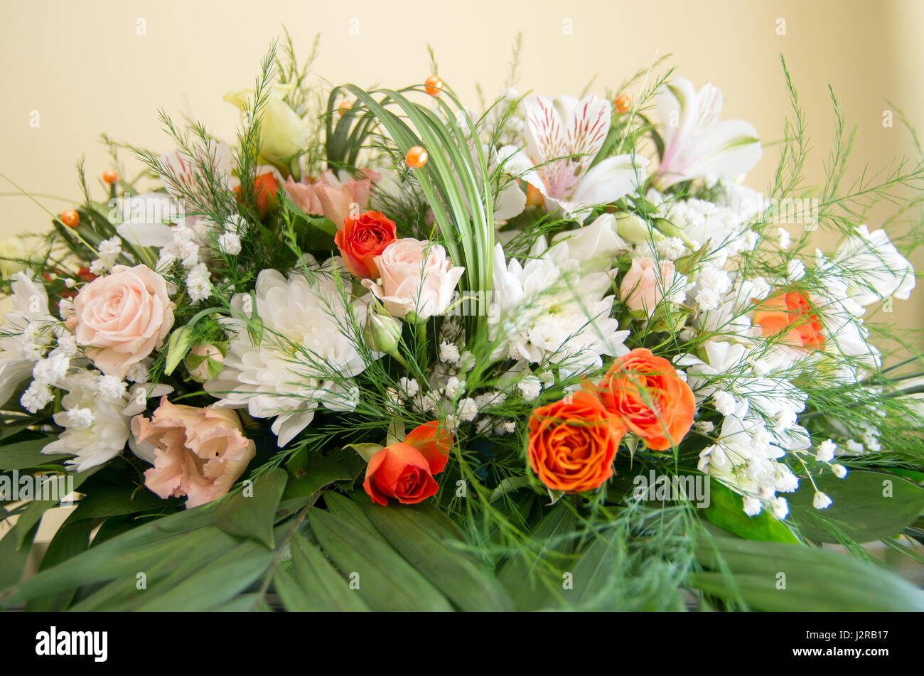 Fresh and fragrant flowers arranged with decorative leaves and grasses Stock Photo