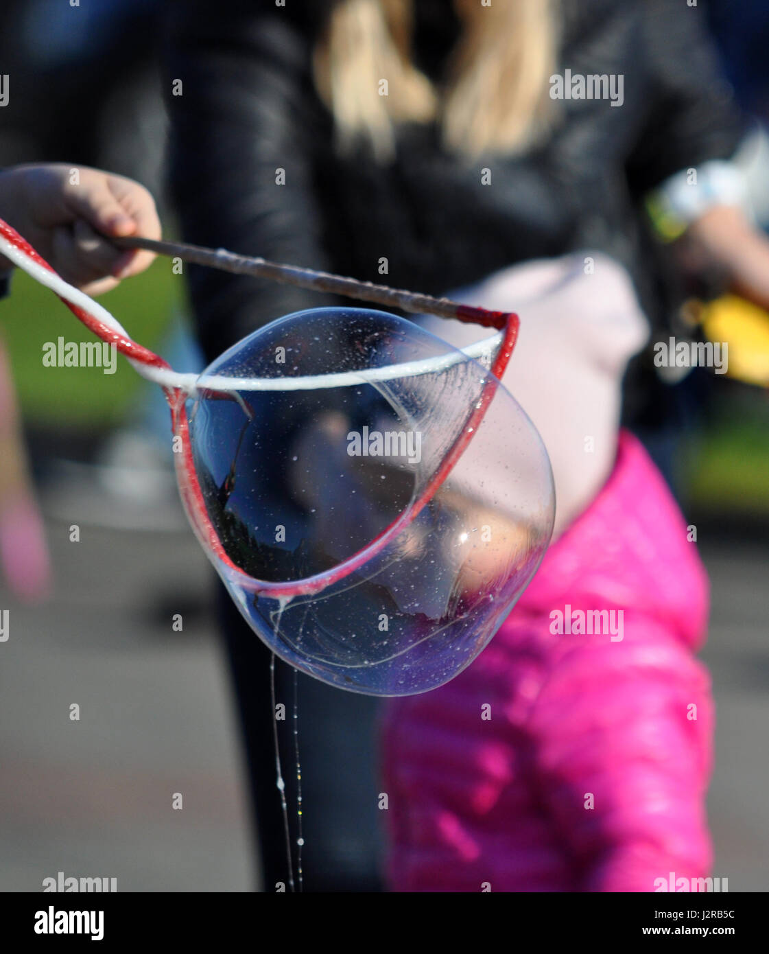 Playing with soap bubbles on the street of Gdynia, Poland, spring time Stock Photo