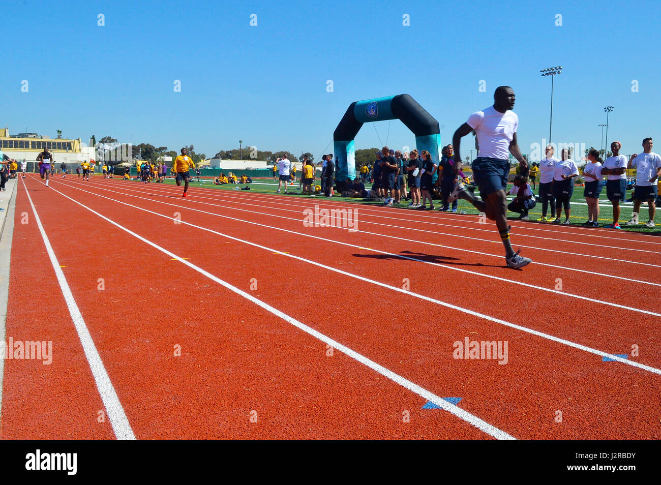 170421-N-IE405-184 SAN DIEGO (April 21, 2017)  Sonar Technician (Surface) Seaman Jerrod Davis assigned to USS Boxer (LHD 4) completes the last lap and wins the running baton relay race during the third annual SAPR Cup competition. More than 650 Sailors from 28 commands participated in this year’s SAPR Cup competition to further educate, promote SAPR awareness and culture of professionalism. (U.S. Navy photo by Mass Communication Specialist 2nd Class Indra Bosko/Released) Stock Photo