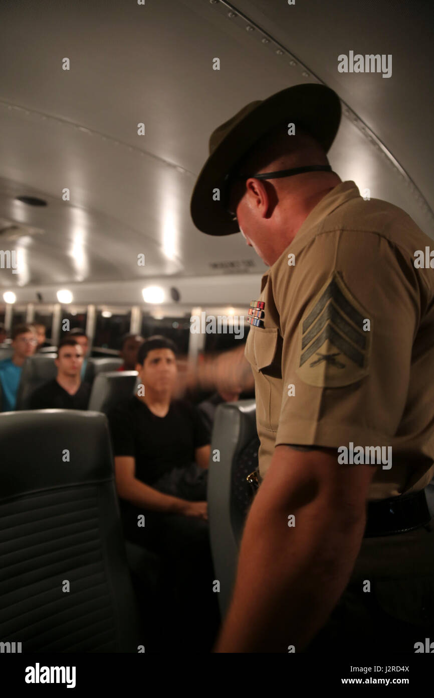 Sgt. Steven J. Kilpatrick, drill instructor, Receiving Company, welcomes the new recruits of Mike Company, 3rd Recruit Training Battalion, to the depot as they prepare to exit the bus and stand on the yellow footprints during receiving at Marine Corps Recruit Depot San Diego, April 24. From this point on, recruits will eat, sleep and train as a team as they begin the transformation from civilian to Marine. Annually, more than 17,000 males recruited from the Western Recruiting Region are trained at MCRD San Diego. Mike Company is scheduled to graduate July 21. Stock Photo