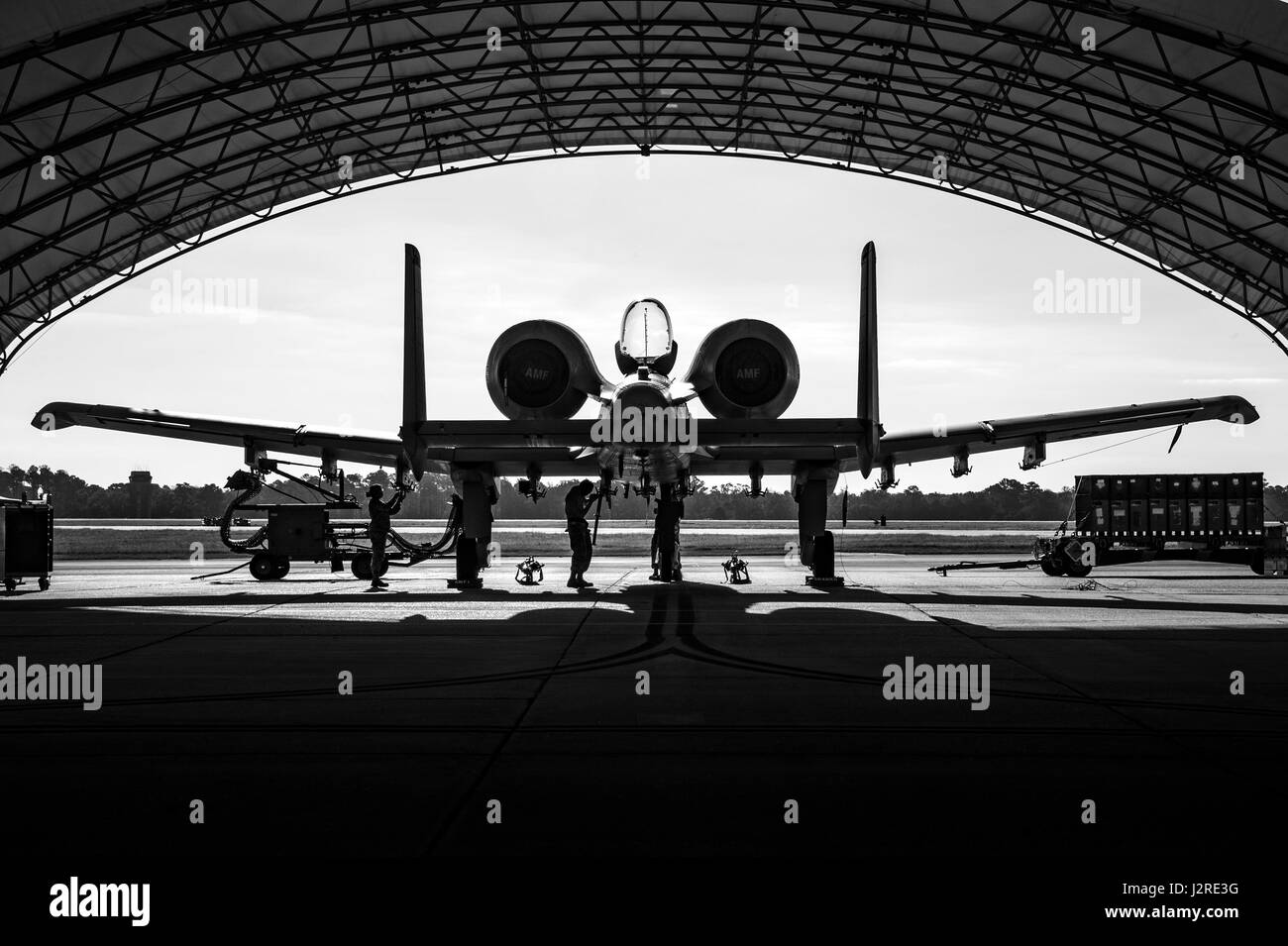 Weapons Airmen from the 75th Aircraft Maintenance Unit reconfigure an A-10C Thunderbolt II, April 25, 2017 at Moody Air Force Base. The A-10 can employ a wide variety of conventional munitions, including general purpose bombs, cluster bomb units, laser guided bombs, joint direct attack munition, AGM-65 Maverick and AIM-9 Sidewinder missiles, rockets, and illumination flares. The GAU-8/A 30mm cannon is capable of firing 3,900 rounds per minute to defeat a wide variety of targets, including tanks. (U.S. Air Force photo by Andrea Jenkins) Stock Photo