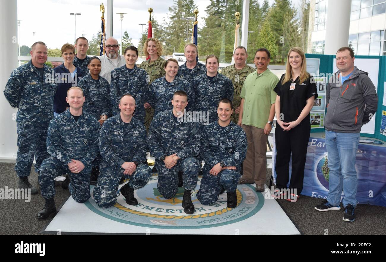 Highlighting the team effort... Naval Hospital Bremerton staff and visitors gather on NHB's Quarterdeck as the command commemorates Earth Day on April 25 as the recipient of the Chief of Naval Operations (CNO) Environmental Award for Fiscal Year 2016. “NHB earned our CNO Environmental Award recognition because of one reason; the high quality of our people. Through a true team effort, led by our Facility Department and our Environmental Management Division, we have managed to improve our sustainability posture,” said Capt. David K. Weiss, Naval Hospital Bremerton Commanding Officer (Official Na Stock Photo