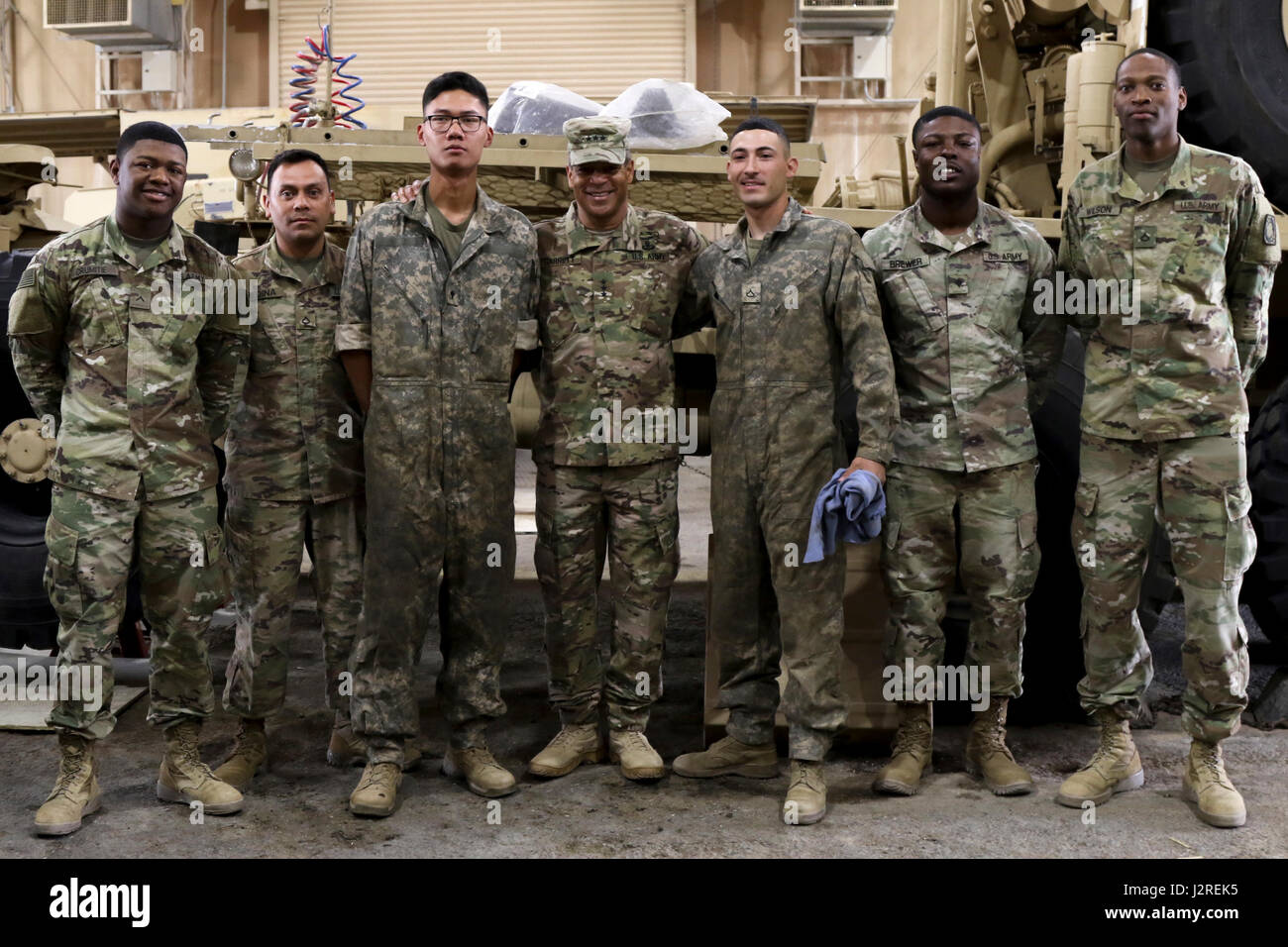 Lt. Gen. Michael Garrett, commanding general of U.S. Army Central, poses with mechanics from the 4th Battalion, 5th Air Defense Artillery Regiment, during a capabilities tour, at Camp Arifjan, April 26. The mechanics maintain various equipment for the 5th ADA, and are a vital asset to the readiness of the force. (U.S. Army photo by Sgt. Bethany Huff, USARCENT Public Affairs) Stock Photo