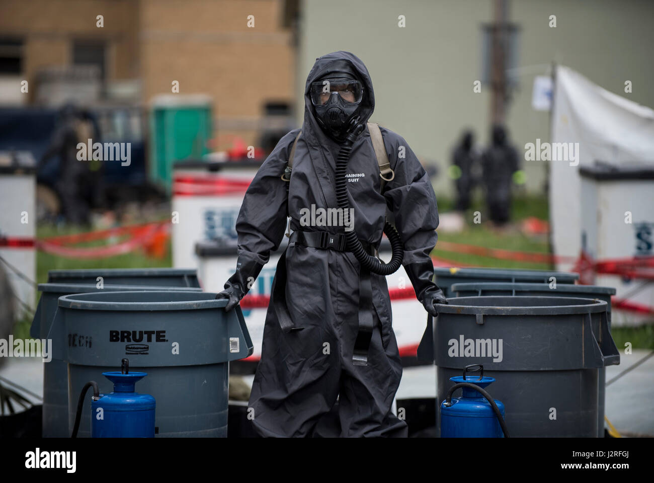 A U.S. Army Soldier with the 51st Chemical Biological Radiological Nuclear Company, of Fort Stewart, Georgia, stands watch at a decontamination field site during Guardian Response 17 at the Muscatatuck Urban Training Center, Indiana, April 27, 2017. Guardian Response, as part of Vibrant Response, is a multi-component training exercise run by the U.S. Army Reserve designed to validate nearly 4,000 service members in Defense Support of Civil Authorities (DSCA) in the event of a Chemical, Biological, Radiological and Nuclear (CBRN) catastrophe. This year's exercise simulated an improvised nuclear Stock Photo
