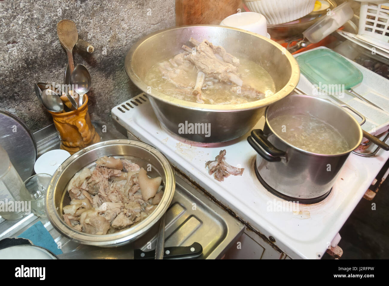 A view of pork meat boiling in the pot on the stove Stock Photo - Alamy