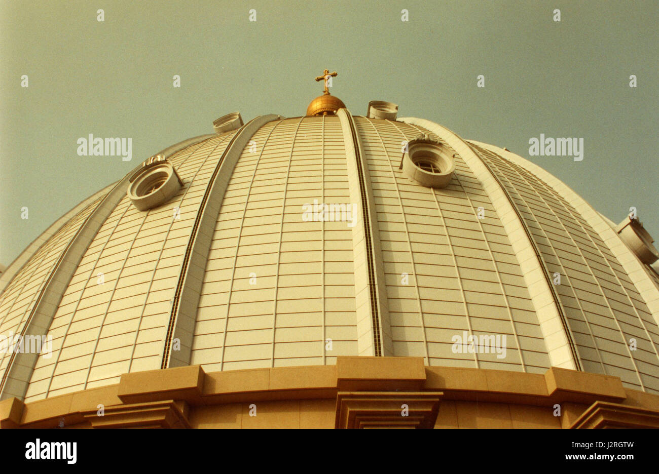 Photograph of a cross mounted on the top of a church building ...