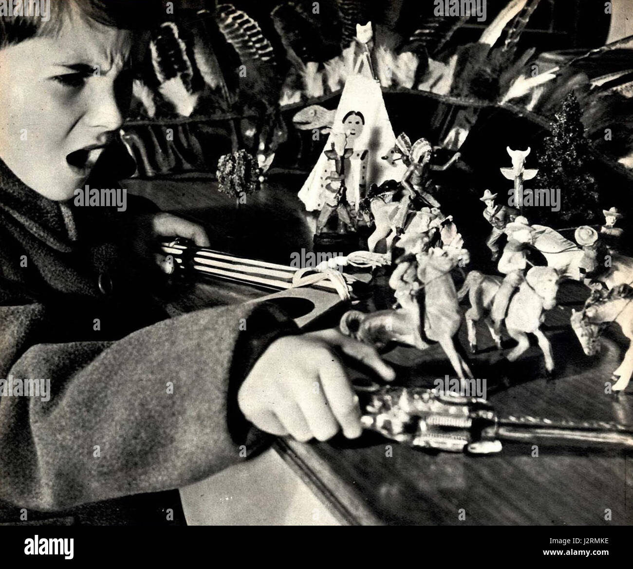 1951 child playing with tin soldiers Stock Photo