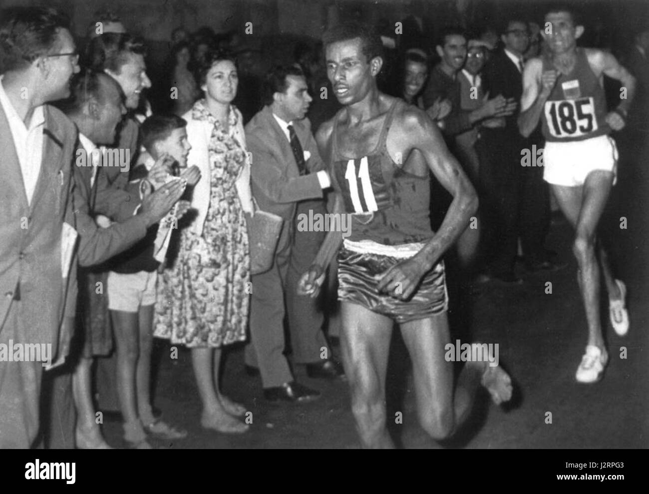 Abebe Bikila sprints away from Rhadi Ben Abdesselam near the end of the marathon at the 1960 Rome Olympics Stock Photo