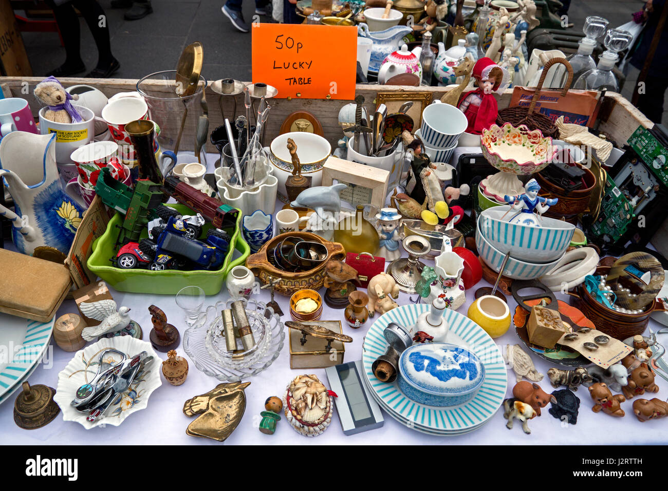 50p bric-a-brac for sale on a stall in the Grassmarket in Edinburgh's Old Town. Stock Photo