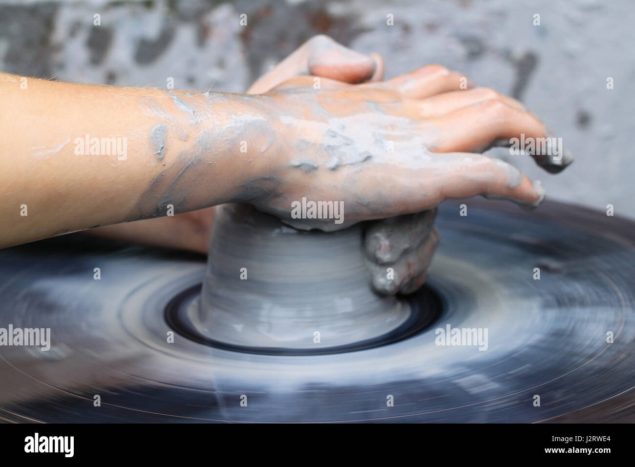 Pottery making, teaching pottery. A lump of wet clay begins to form a