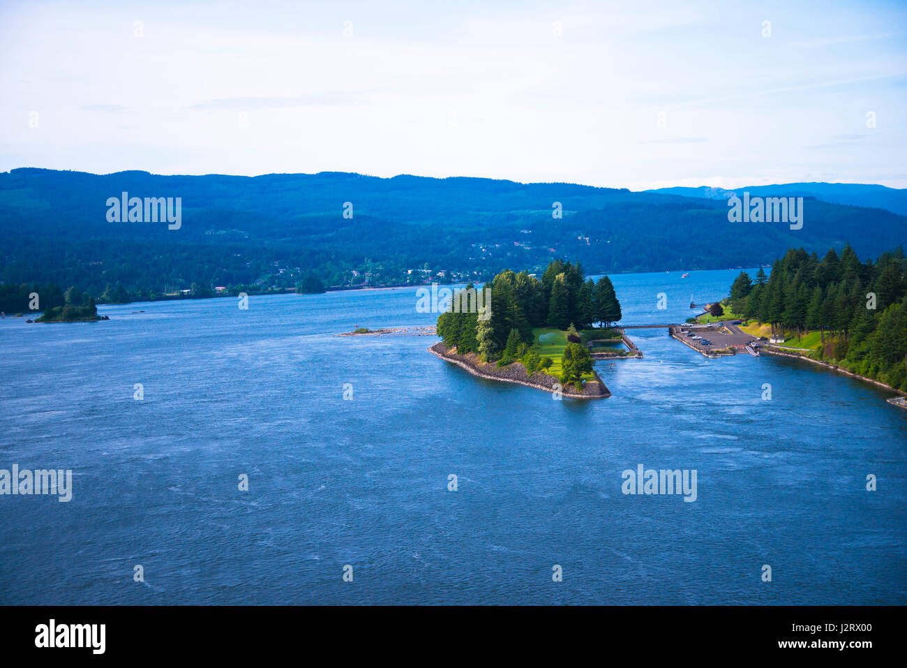 Green island covered with trees on the Columbia River in the scenic ...