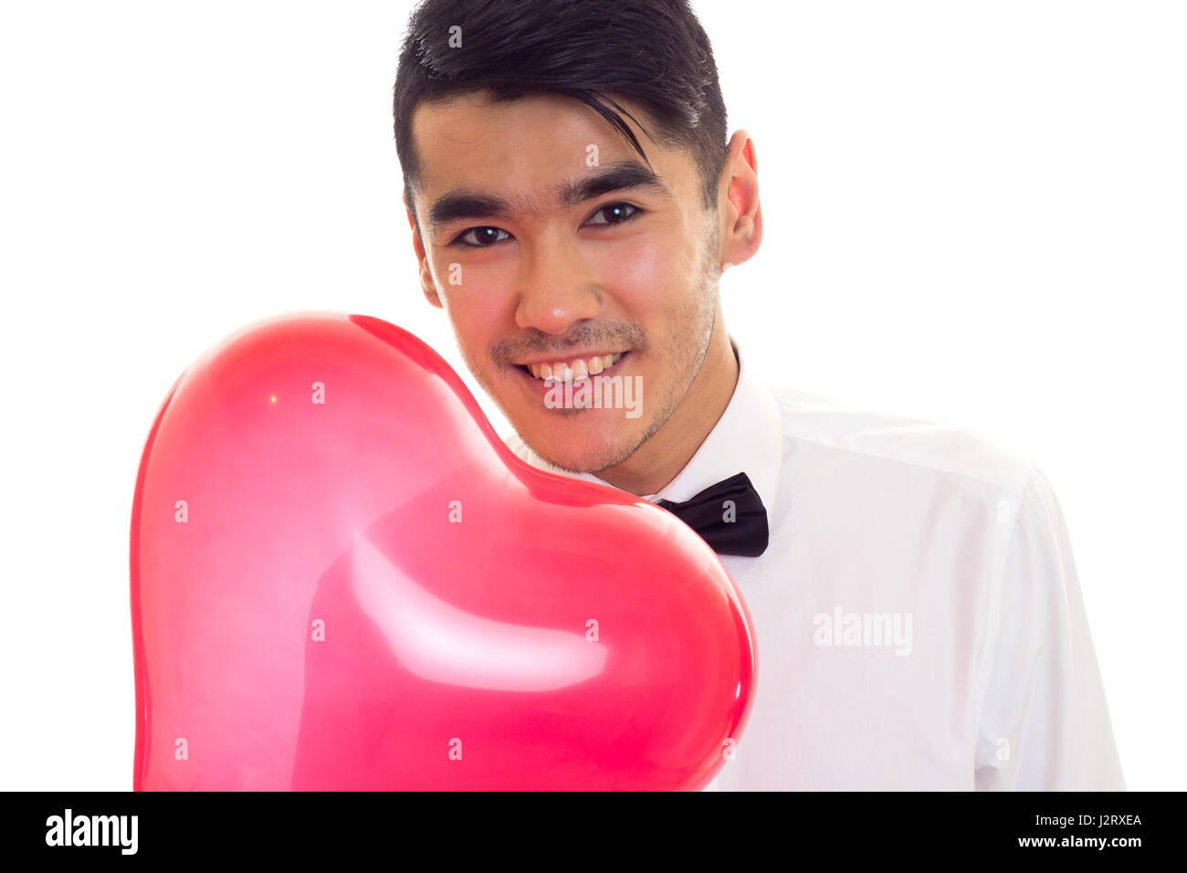 Young man with bow-tie holding balloon Stock Photo