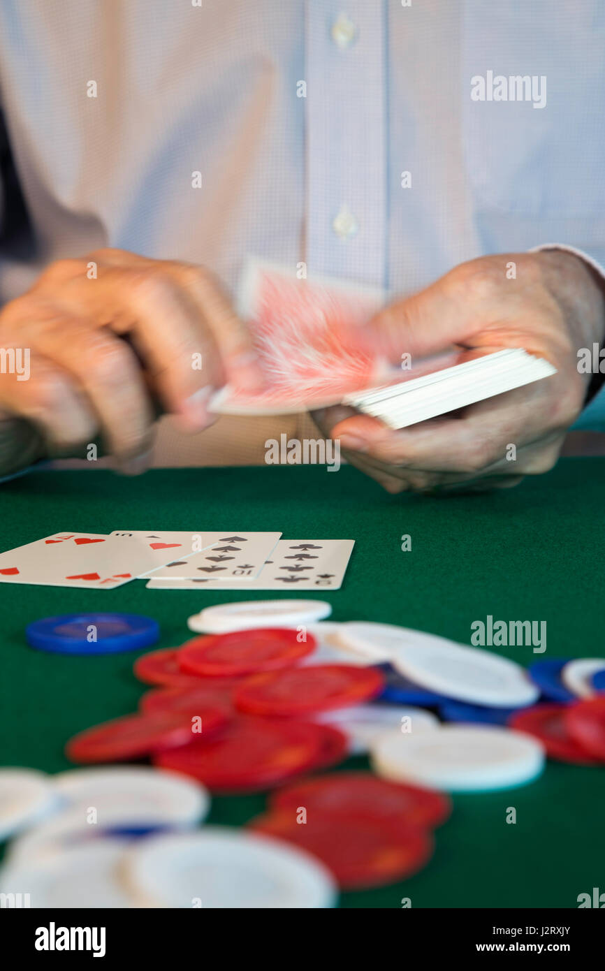 Man Dealing Cards at Poker Game Stock Photo