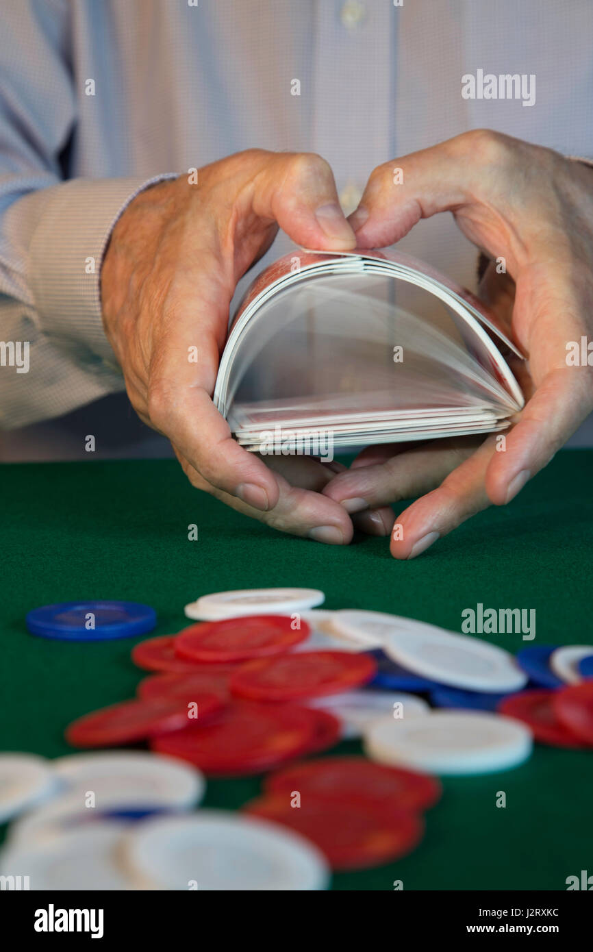 Man Shuffling Cards at Poker Game Stock Photo