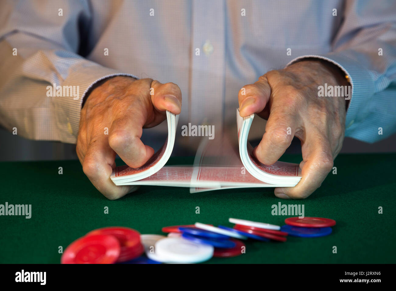 man Shuffling Cards Dealing at Poker Game Stock Photo