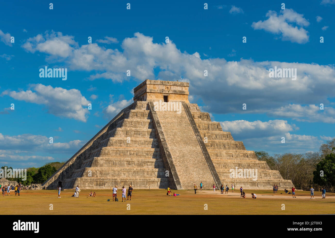 El Castillo maya pyramid during summer solstice with the snake shadow by the stairs with tourists enjoying the view in Chichen Itza, Yucatan, Mexico. Stock Photo