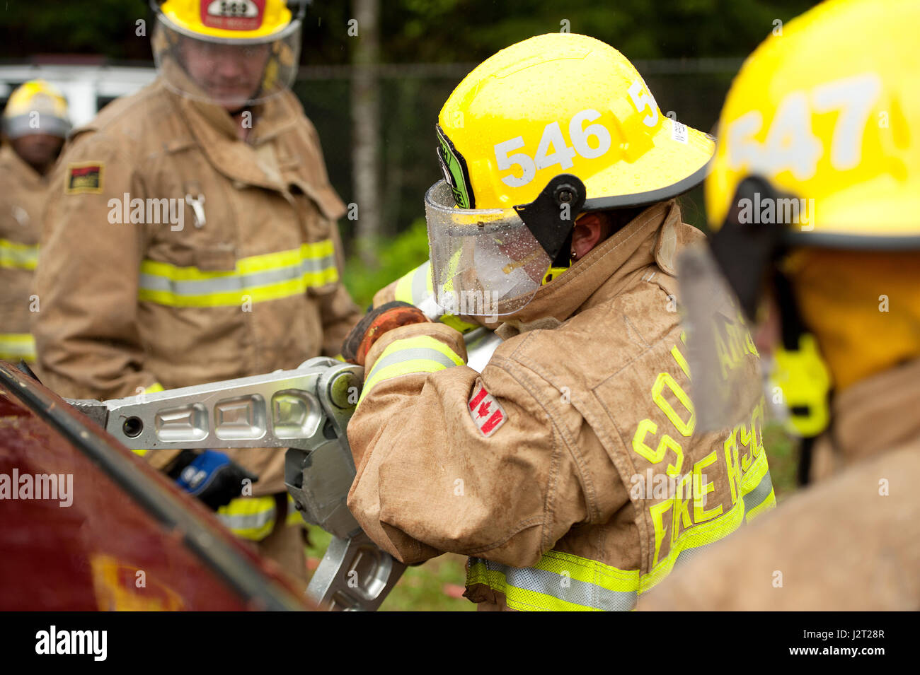 Trainee fire fighter and Howe Sound Secondary student Kei Gray uses the Jaws of Life during a vehicle extraction exercise. Stock Photo