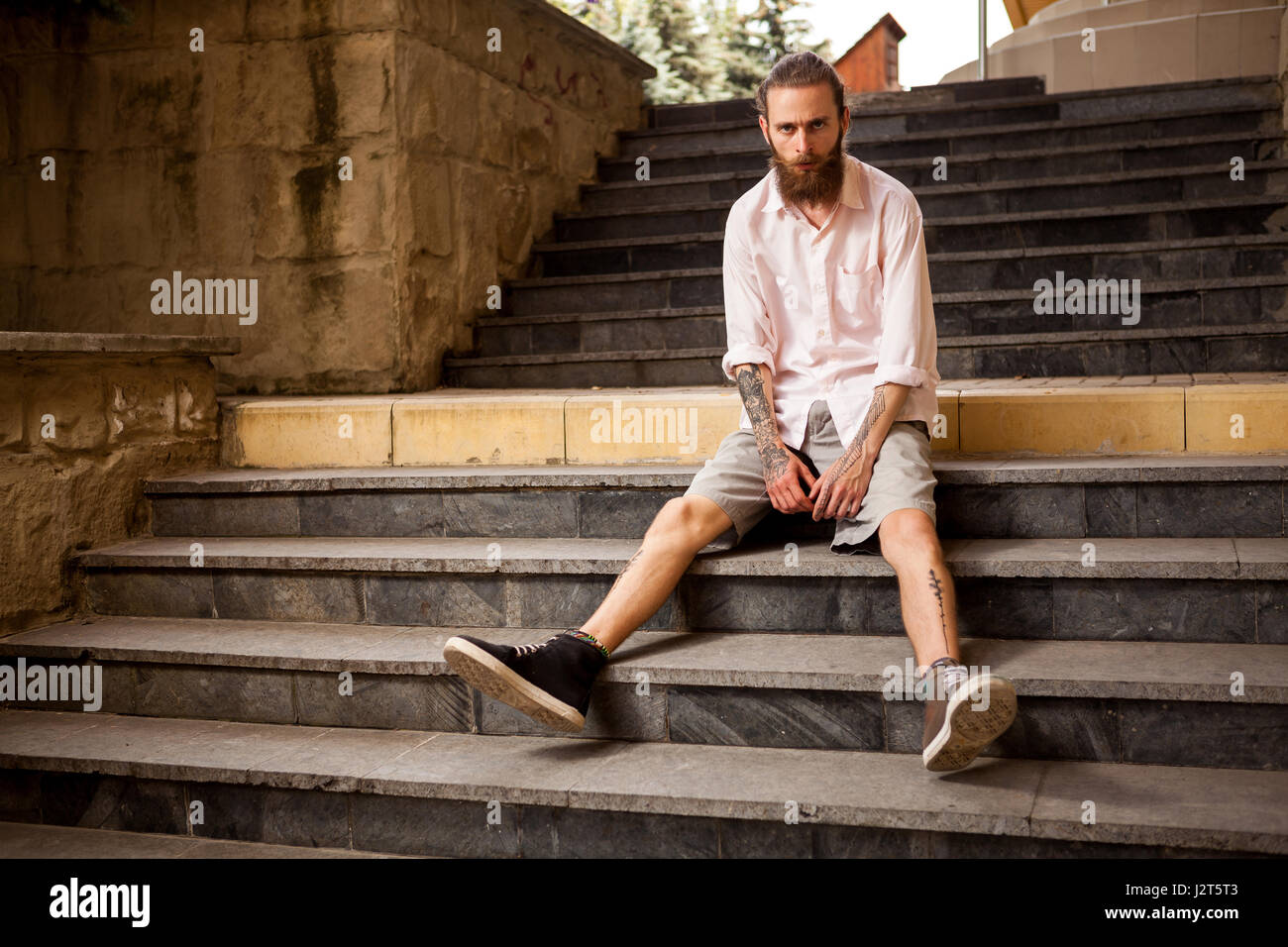 Tattoed and bearded hipster posing outdoor Stock Photo