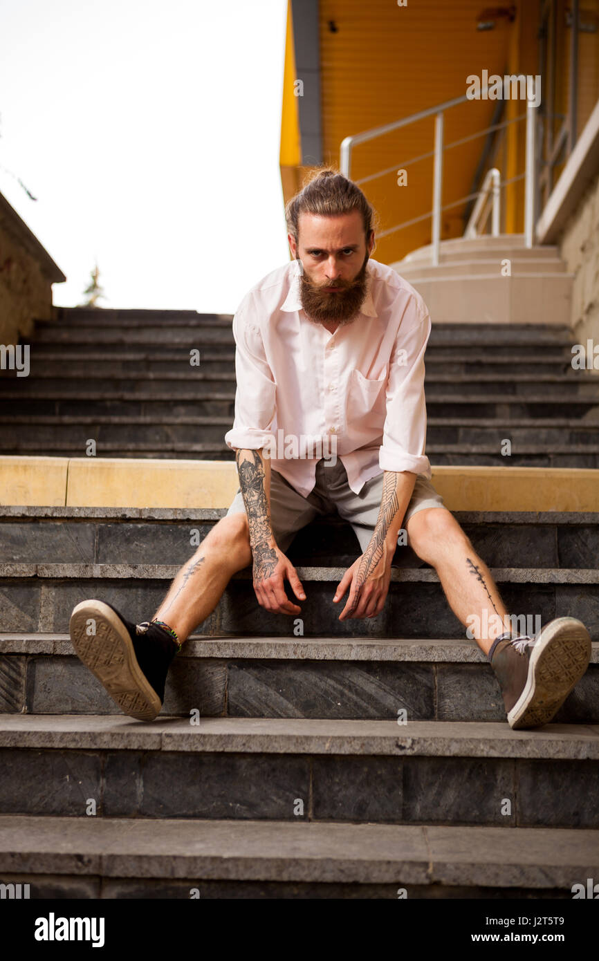 Tattoed and bearded hipster posing outdoor Stock Photo
