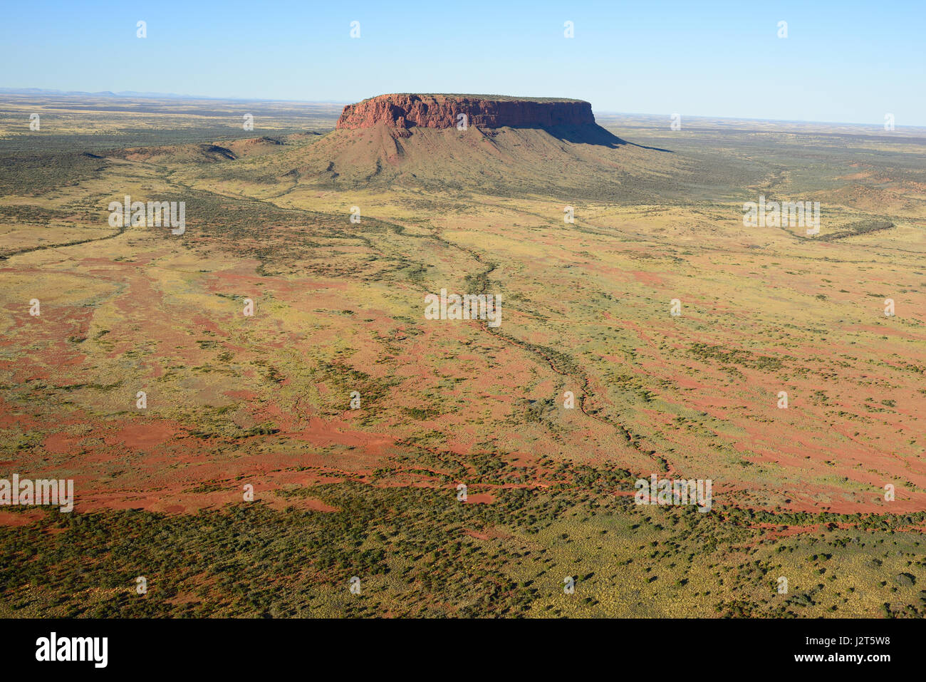 AERIAL VIEW. Mount Conner; an isolated mesa (or inselberg) in the red centre of Australia. Northern Territory, Australia. Stock Photo