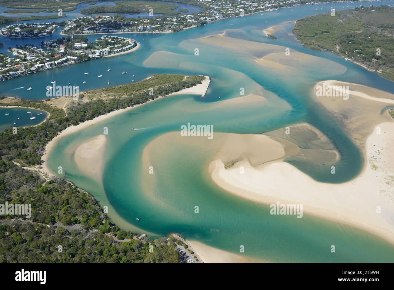 AERIAL VIEW. Seaside resort near the mouth of a colorful estuary. Noosa Heads, Sunshine Coast, Queensland, Australia. Stock Photo
