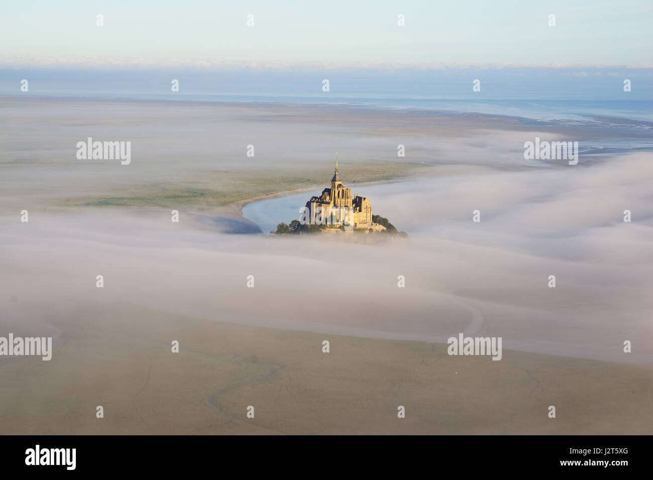 AERIAL VIEW. Abbey on a lofty rocky island in an intertidal zone. Mont Saint-Michel, Manche, Normandie, France. Stock Photo