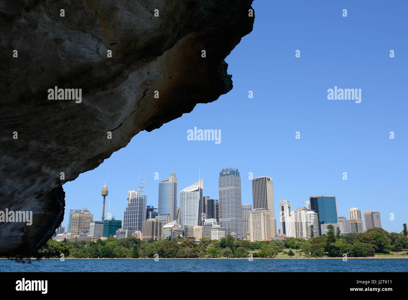 Skyline of Sydney's highrises framed by a rocky overhang. New South Wales, Australia. Stock Photo