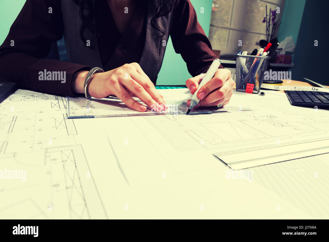 Hands of architect woman working on blueprints Stock Photo - Alamy
