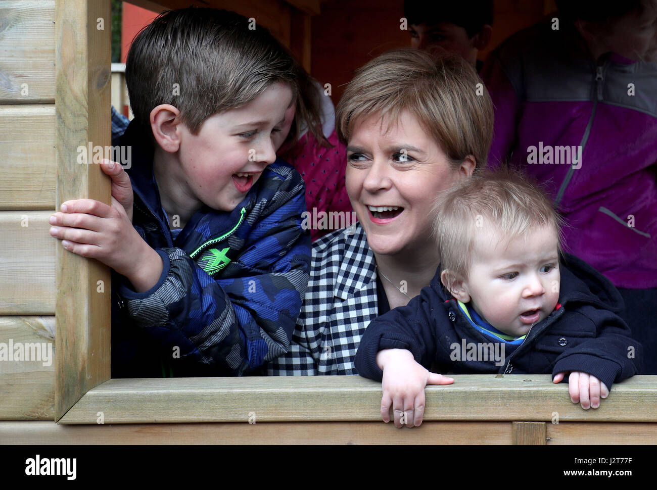 SNP leader Nicola Sturgeon with Scott Ruddick, 7, (left) and his baby brother Alastair Ruddick, 9 months, during a visit to to the Dreams Daycare nursery in Insch, Aberdeenshire, on the election campaign trail. Stock Photo