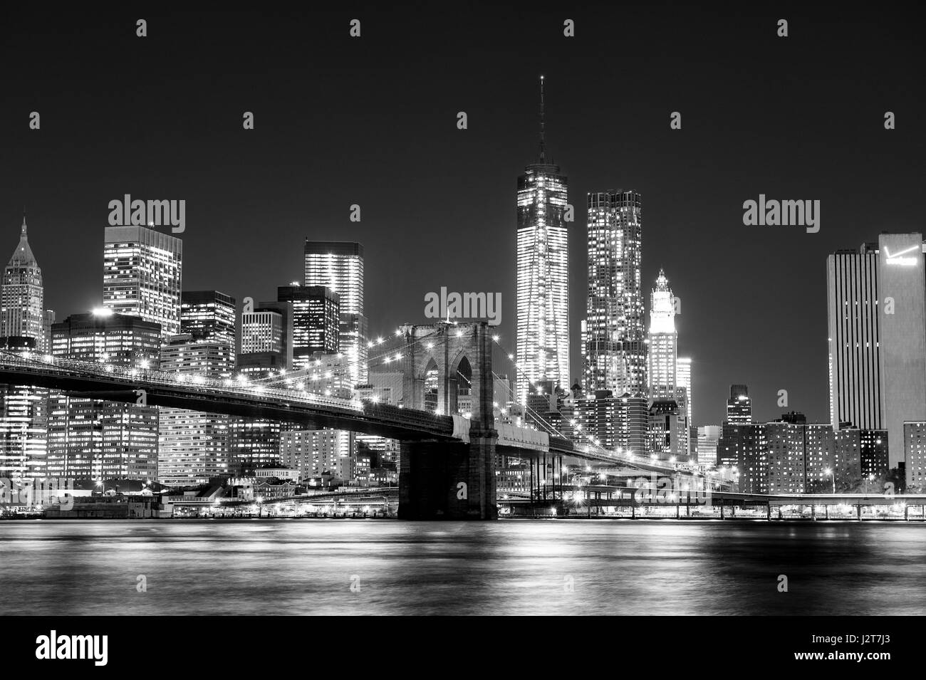 The Manhattan skyline and Brooklyn Bridge at night seen from Brooklyn Bridge Park in Brooklyn, New York. Stock Photo