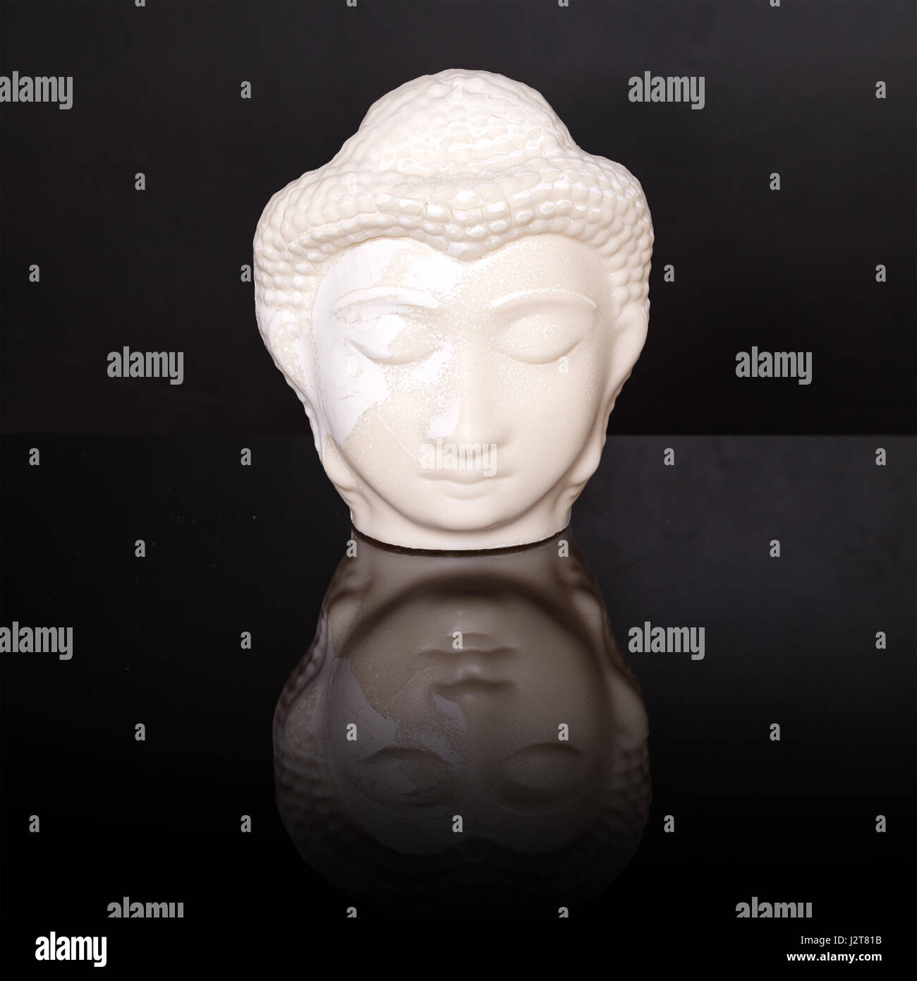 Buddha face. Buddha statue made of white marble on black background