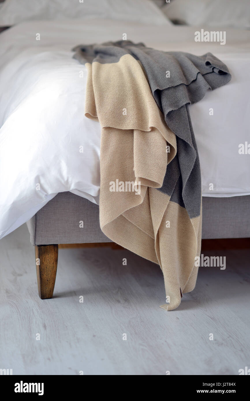 Luxury bedspread on unmade bed. Stock Photo