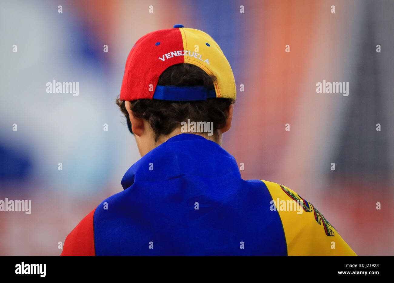 Miami, Florida, USA. 29th Apr, 2017. A Miami FC fan displays a baseball cap with the Venezuelan flag colors and country's name, as he is involved with the Venezuelan flag, in solidarity with the country's current anti-goverment uprising, during a North American Soccer League game between FC Edmonton vs Miami FC at the Riccardo Silva Stadium in Miami, Florida. Miami FC won 2-0. Mario Houben/CSM/Alamy Live News Stock Photo