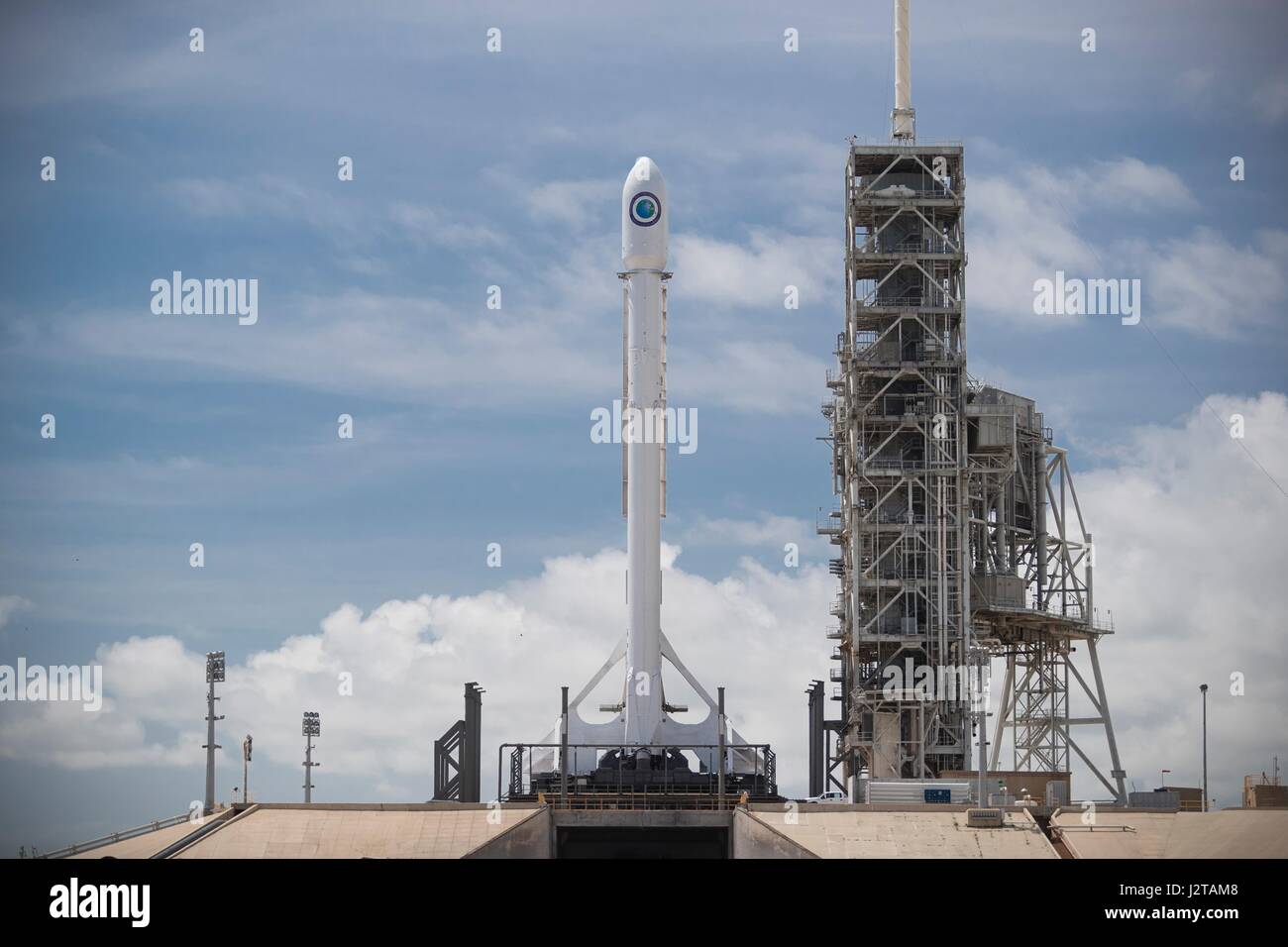 The SpaceX Falcon 9 rocket carrying a classified military satellite sits on Launch Complex 39A ready for blast off at the Kennedy Space Center April 29, 2017 in Cape Canaveral, Florida. The SpaceX mission was scrubbed at the last minute due to a faulty sensor and will try again on May 1st. Stock Photo