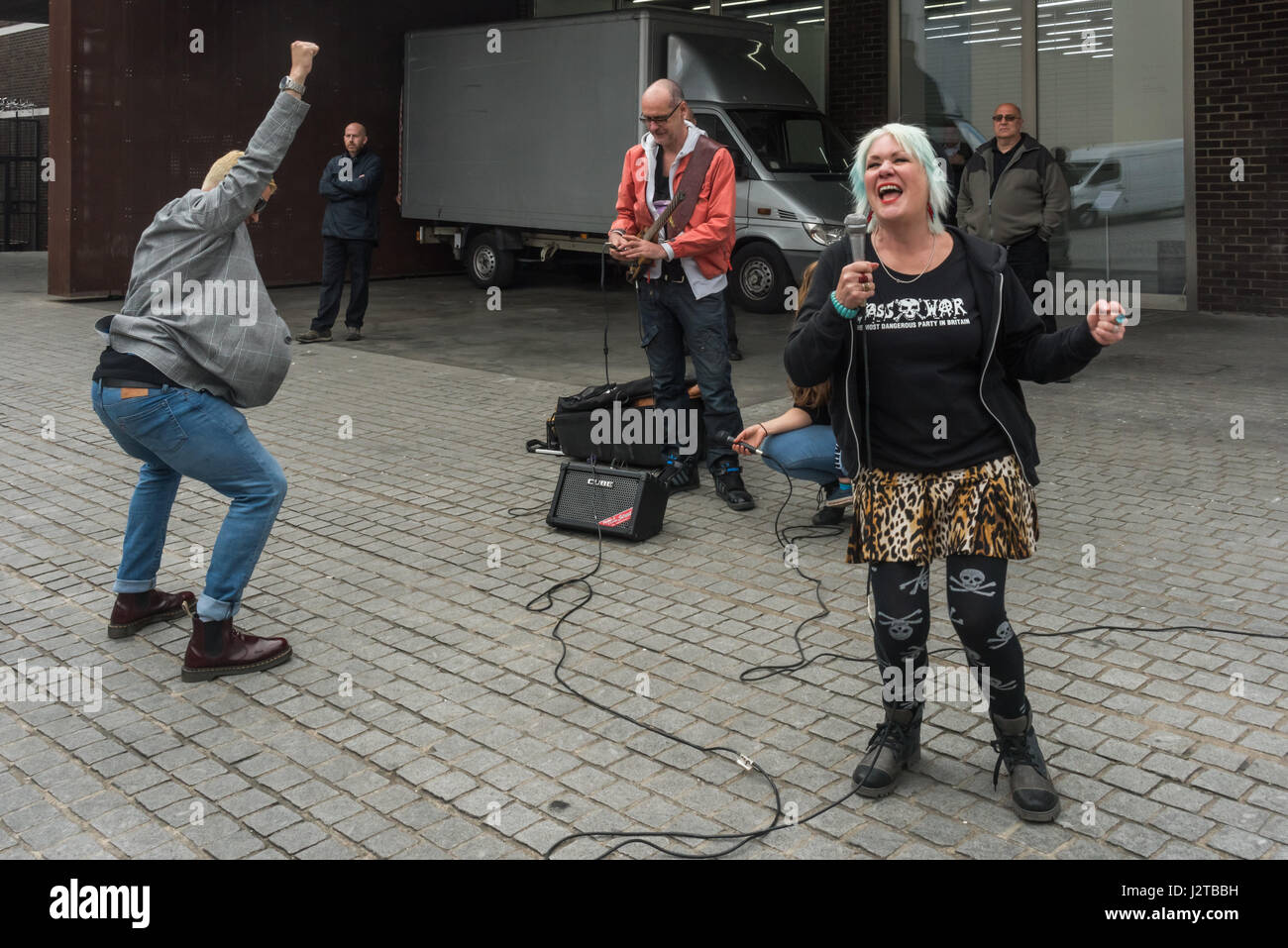 London, UK. 30th April 2017. Jane Nicholl recites as an introduction to a performance by Adam Clifford (aka Jimmy Kunt) at the Class War protest against gentrification outside Bermondsey's White Cube gallery. There were also performances by Cosmo, Potent Whisper nd others, along with speeches by Simon Elmer of ASH, Martin Wright and Ian Bone. Credit: Peter Marshall/Alamy Live News Stock Photo