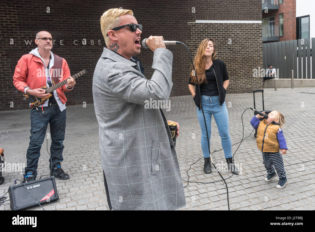 London, UK. 30th April 2017. Adam Clifford (aka Jimmy Kunt) performs with the help of a young backing vocalist at the Class War protest against gentrification outside Bermondsey's White Cube gallery. There were also performances by Cosmo, Potent Whisper nd others, along with speeches by Simon Elmer of ASH, Martin Wright and Ian Bone. Credit: Peter Marshall/Alamy Live News Stock Photo