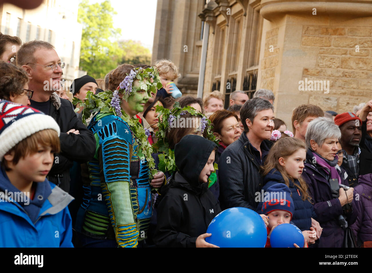 Oxford, UK. 1st May, 2017. Crowds celebrate May morning in Oxford, dressing up, decorating their hats with flowers and some paint their faces green to emulate the green amn. Crowds watch the Morris men dance in front of Hertford College's Bridge of Sighs with the sun rising behind the bridge. May morning is traditionally celebrated in Oxford with a choir singing from the top of Magdalen College Tower after which the crowds are lead through the streets by Morris men who perform at various sites throughout the city. Credit: Jill Walker/Alamy Live News Stock Photo